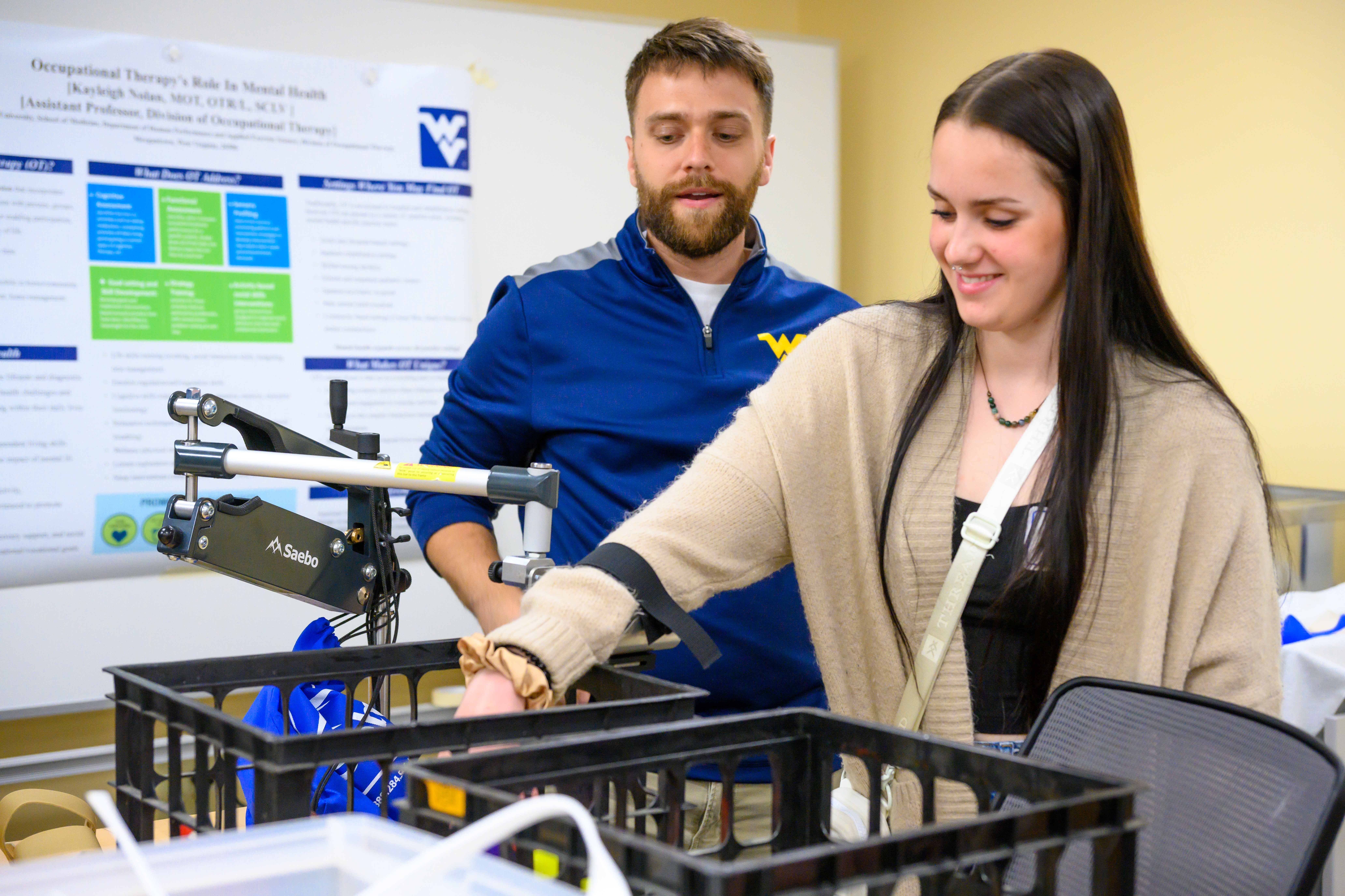 Faculty member explains tools on table to group
